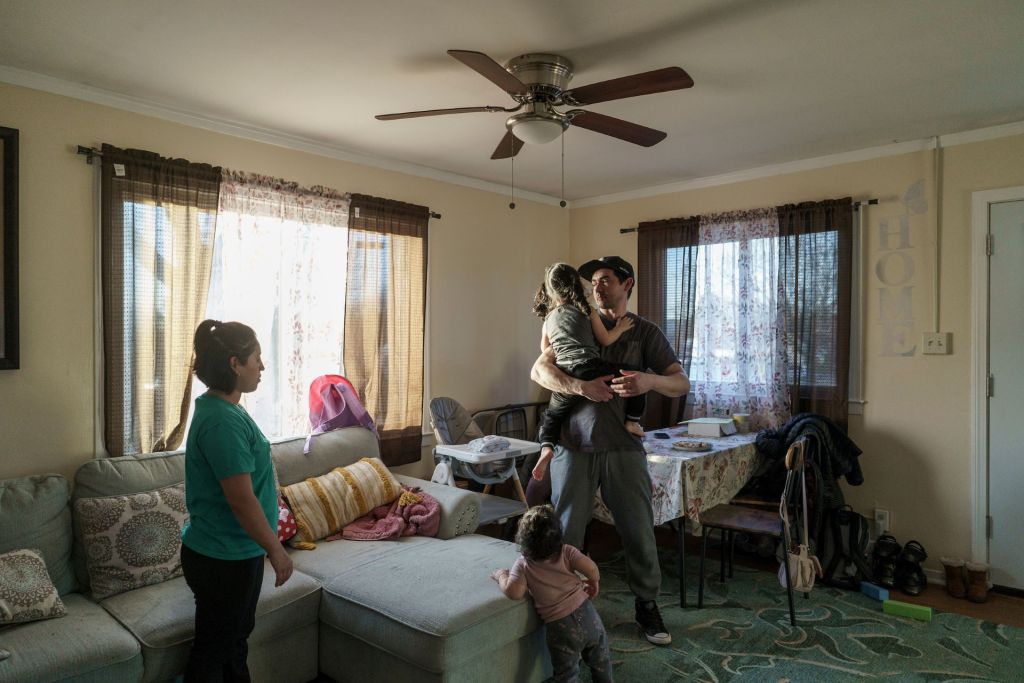 Edson Pereira and Suany Ortiz play with their daughters on a Friday afternoon. Their eldest was lead poisoned while they were living in a previous apartment. 
